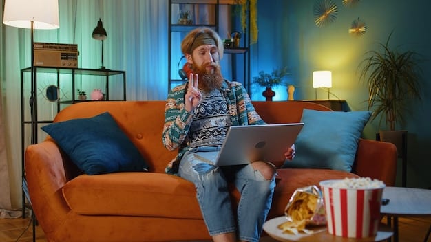 A person sitting on a couch with a laptop on their lap, watching a movie on a streaming service, with a remote control in hand and a relaxed expression.