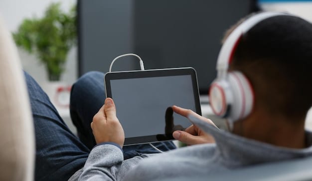 A person wearing headphones and watching a movie on a tablet. The screen shows a scene from the movie with clear audio description narration filling in the gaps between dialogues. The person has a relaxed expression, enjoying the film and the audio description.