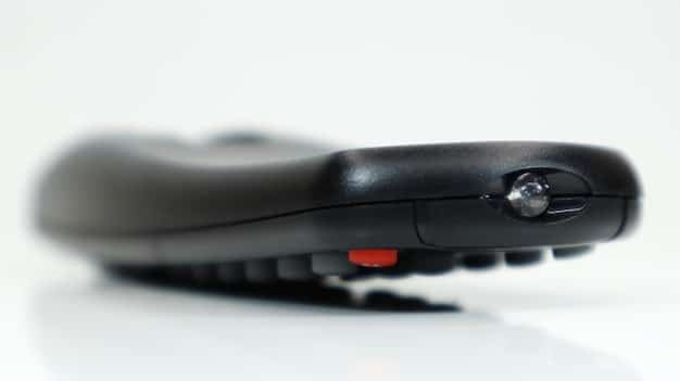 A close-up shot of the Amazon Fire TV Stick 4K Max plugged into the HDMI port of a modern 4K television. The focus is on the device and the television's connection panel, highlighting the sleek design and ease of installation. In the background, a living room setting is subtly visible, suggesting a comfortable and immersive viewing experience.