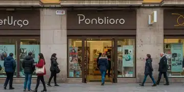 Marketing de proximidad: Aumenta tu clientela local un 30% en España Fachada de un negocio local vibrante en una calle concurrida de España, atrayendo a peatones y clientes.
